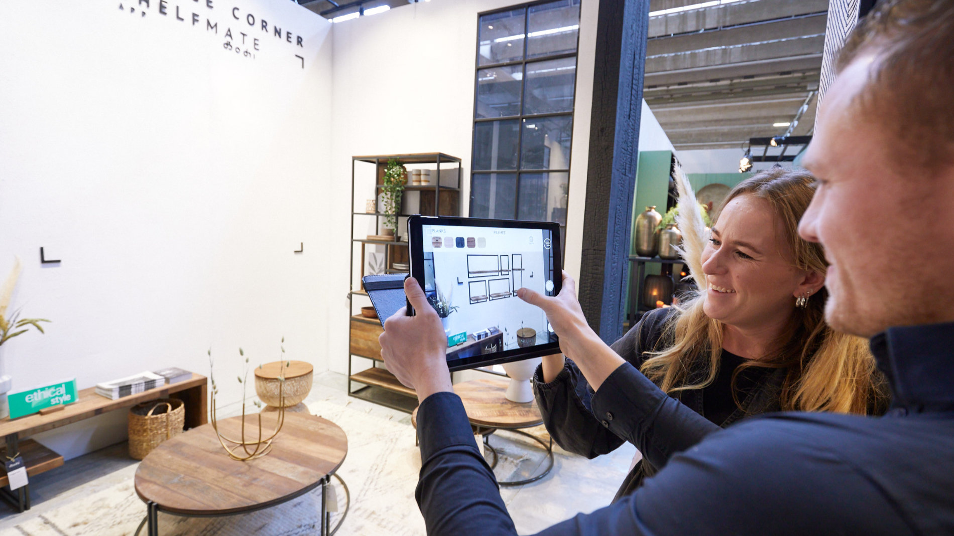 Woman and man at a tablet in front of a trade fair stand