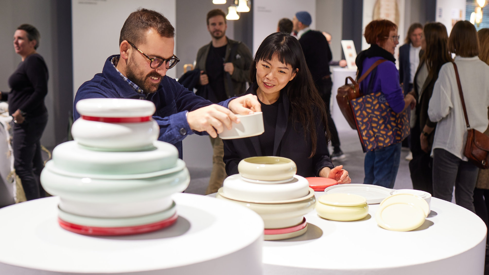 Woman and man at a table with a large vase at Ambiente in Frankfurt